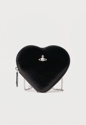 Bolso en forma de corazón negro con una correa de cadena plateada y un pequeño logo de orbe plateado centrado en la parte frontal.