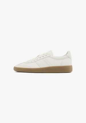 White suede sneakers with a low profile, round toe, and gum rubber sole. Features three textured stripes on the sides.