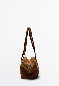 Brown suede handbag with a zip closure, dual handles, soft texture, and a rounded shape. Minimalistic design with no additional accents.