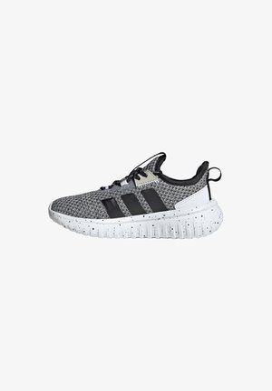 Black and gray knitted athletic shoe with three black stripes, white speckled sole, and black laces on a white background.