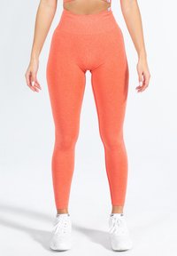 Hoge, nauwsluitende leggings in feloranje, gemaakt van rekbaar materiaal met een gladde textuur. Voorzien van een naadloze tailleband.