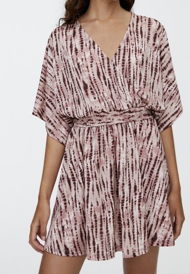 Wrap dress in light pink with dark brown vertical stripes, V-neck, short wide sleeves, and an elastic waistband. Soft, flowing fabric.