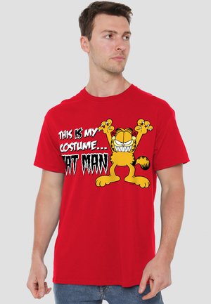 Red cotton t-shirt featuring a cartoon cat with arms raised, text reading "THIS IS MY COSTUME... CAT MAN," and a round neckline.