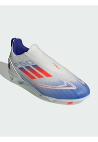 Football boot featuring a sleek white upper with blue and red accents, ribbed texture, and a lightweight design, suitable for turf.