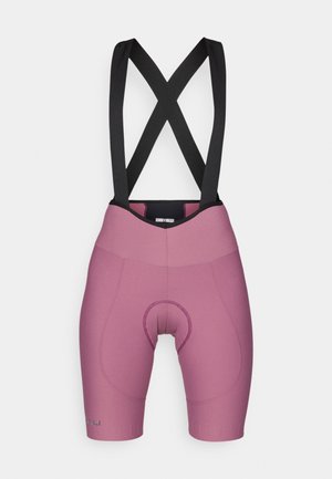 Sykkeltights i lys rosa med svarte seler, polstret sete og glatt elastisk materiale med en tettsittende silhuett.