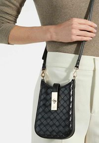 Black quilted leather handbag with a rectangular shape, featuring a gold-tone clasp and adjustable strap. Smooth texture with subtle detailing.