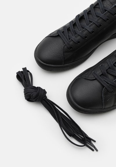 Black leather sneakers with textured surface, round toes, and flat laces. Includes an additional twisted pair of black laces.