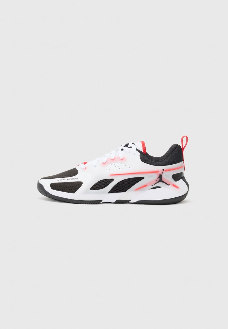Athletic shoes with a white, black, and pink design; mesh upper, rubber sole, perforated accents, and visible branding on the side.