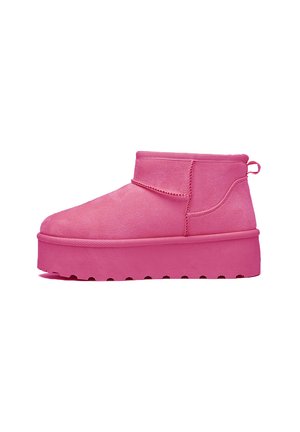 Pink ankle boot with a wide platform sole, made of soft suede-like material. Features stitching accents and a pull tab on the back.