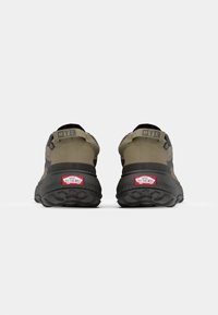 Dark green and black athletic shoes with a rugged sole, featured MTE branding, and a red “Off the Wall” logo on the heel.