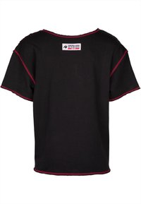 Black t-shirt with a wide neckline and short sleeves. Features contrasting red stitching along the edges and a small logo label on the back.