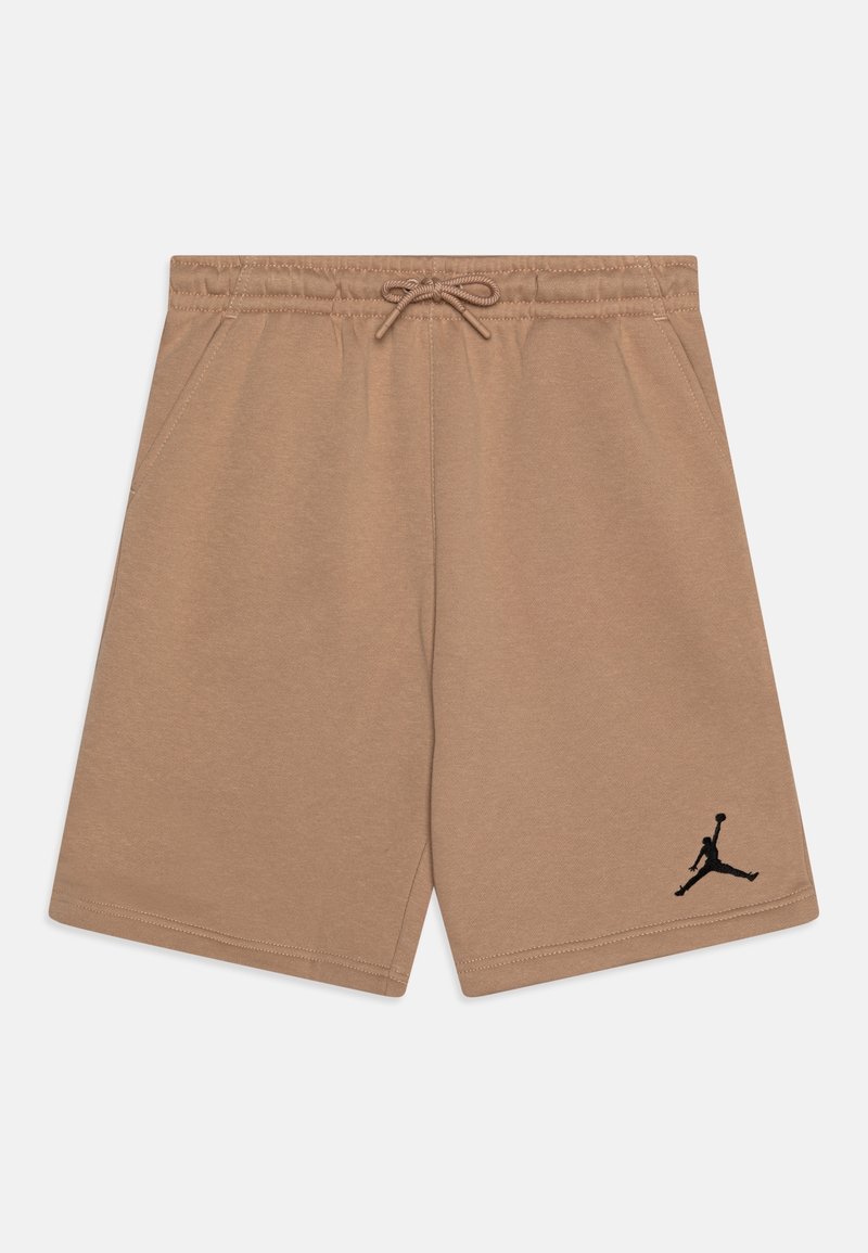 Béžové šortky z měkké látky; mají elastický pas se šňůrkou a černé logo Jumpman na levé noze.