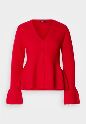 Červený pletený kardigán s výstrihom do V, zapínaním na gombíky a peplum pozdĺžom. Má rebrované rukávy a mäkkú textúru.