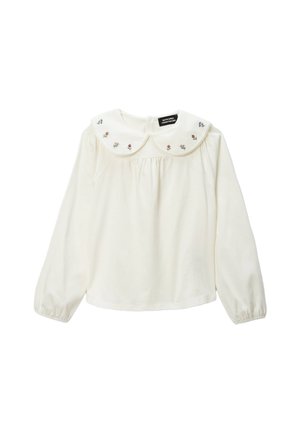 Haut à manches longues de couleur crème avec un grand col Peter Pan brodé orné de motifs floraux et des fronces délicates sur le devant.