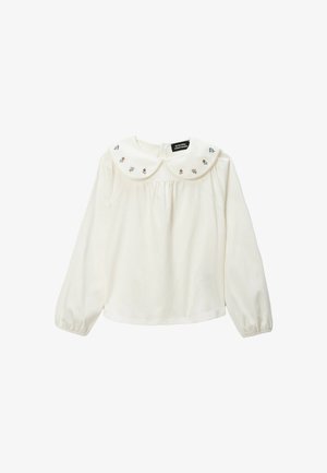 Haut à manches longues de couleur crème avec un grand col Peter Pan brodé orné de motifs floraux et des fronces délicates sur le devant.