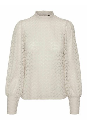 Helebeige pikkade varrukatega pluus kõrge kaelusega. Tekstureeritud kangas on geomeetrilise mustriga. Lahtine lõige, puhvvarrukate ja mansettidega.