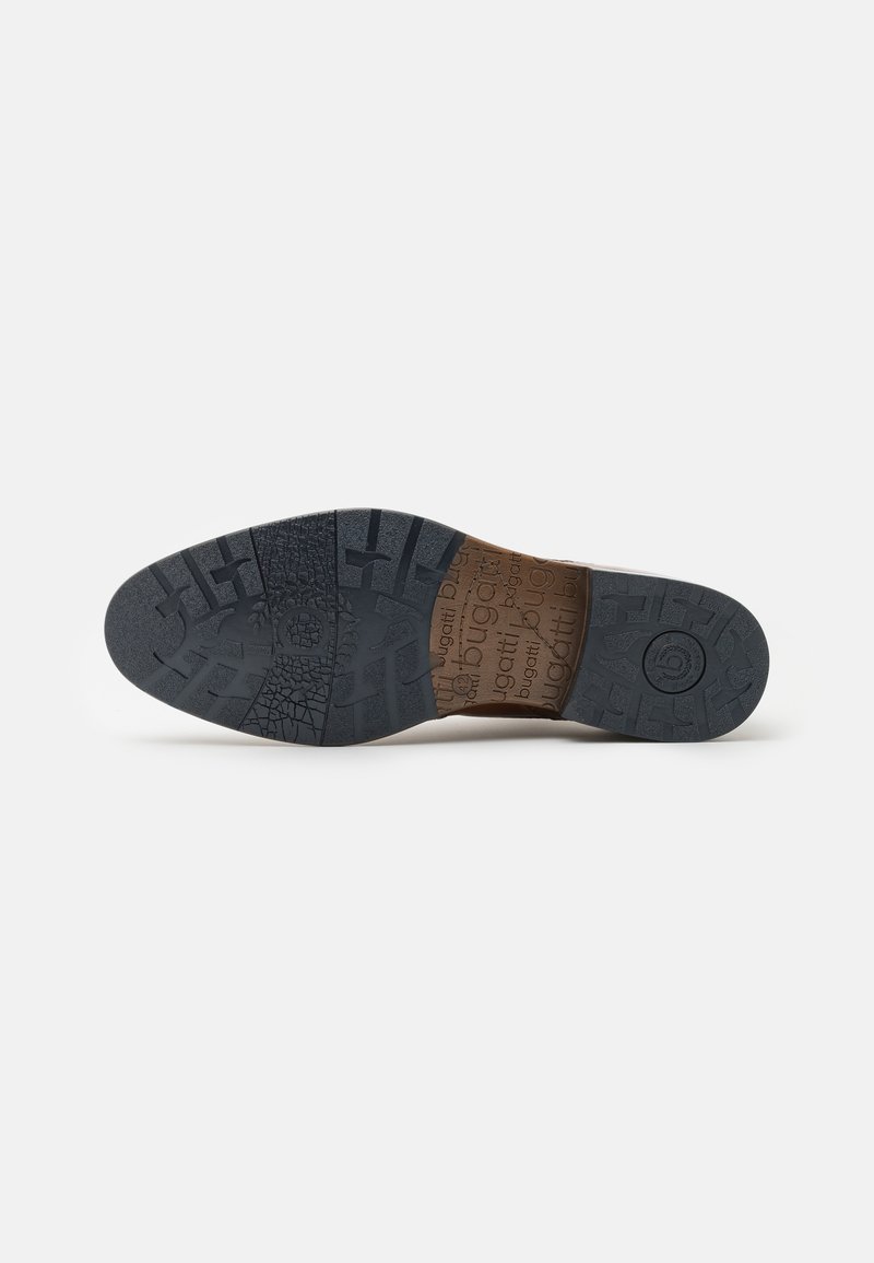 Schuhsohle aus strukturiertem schwarzem Gummi, mit einer geschwungenen Form und einer braunen Einlage, die mit "bugatti" geprägt ist. Detailliertes Profil für besseren Halt.