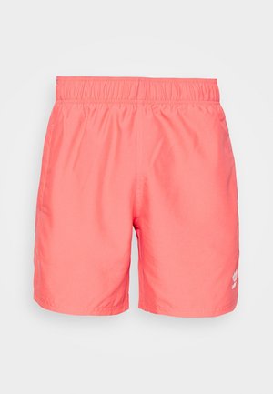 Koralo-różowe męskie kąpielówki z elastycznym paskiem i małym białym logo Adidas na dolnej lewej nogawce.