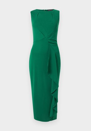 Φόρεμα μίντι σε σμαραγδί πράσινο χωρίς μανίκια, με στρογγυλή λαιμόκοψη και ασύμμετρο βολάν που καταρρέει κατά μήκος της δεξιάς πλευράς.