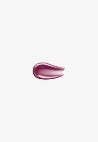 Echantillon lisse et brillant de crème ou maquillage liquide de couleur mauve sur fond blanc.