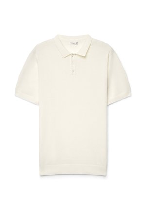 Polo a maniche corte color crema in morbido cotone. Presenta un colletto classico, una patta con tre bottoni e polsini a costine.