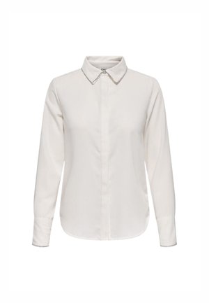 Camicia bianca a maniche lunghe con colletto e chiusura frontale a bottoni. Tessuto liscio con una leggera lucentezza e orlo arrotondato.