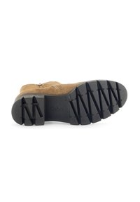 Brown suede boot with a textured black rubber sole featuring a zigzag pattern and the brand name "Gabor" embossed on the side.