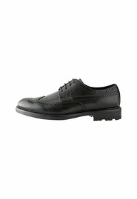 Chaussure brogue en cuir noir avec perforations décoratives, design à lacets, bout arrondi et semelle en caoutchouc texturé pour une meilleure adhérence.