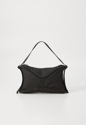 Black handbag with a soft, textured material. Features a wavy design, single shoulder strap, and a subtle logo detail on the front.