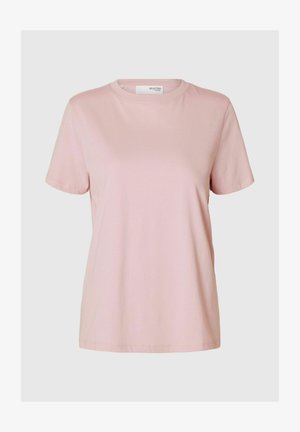 Rozā kokvilnas t-krekls ar īsām piedurknēm, apļa kakla izgriezumu un brīvu piegriezumu. Gluda tekstūra un nav redzamu rakstu vai akcentu.