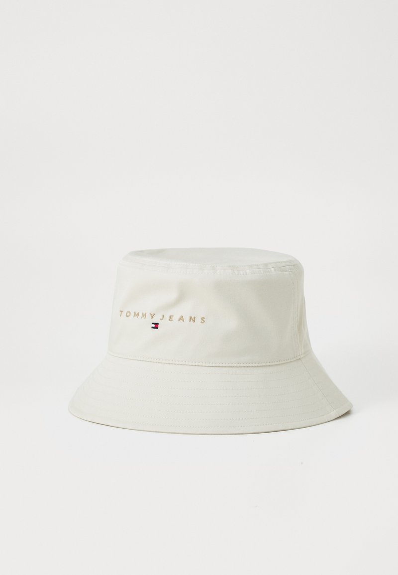 Bucket hat in cream color made of smooth fabric. Features "TOMMY JEANS" embroidered on the front with a small logo accent.