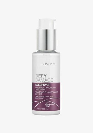 Klart glasflaske med en hvid pumpe og sølvdetaljer. Har lilla og hvide etiketter med produktnavn og detaljer. 100 ml kapacitet.