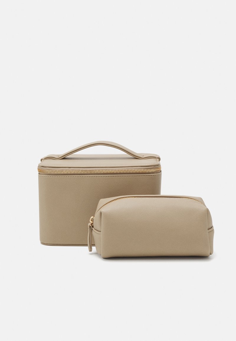 Beige, textured synthetic leather bags, one rectangular with a handle and gold zipper, and a smaller cylindrical bag with a gold zipper.