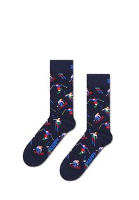 Calcetines de color navy con un patrón juguetón de esquí. El material es suave y cuenta con un puño acanalado. Presenta gráficos coloridos de esquiadores y la palabra "FELIZ."