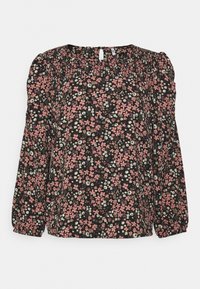 Blouse noire à motifs floraux avec manches longues bouffantes, présentant des motifs de fleurs roses et blanches, un col froncé et une texture de tissu douce.