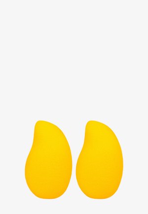 Deux éponges jaunes courbées pour le maquillage avec des pointes fines sur fond blanc.