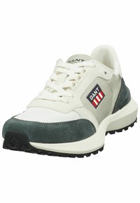 Sneaker featuring a mix of cream mesh and green suede, with a black rubber sole, GANT logo patch, and lace-up design.