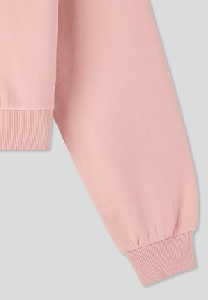 Manica di felpa rosa chiaro con polsino a coste, realizzata in tessuto morbido, caratterizzata da una superficie liscia e da un design a vestibilità rilassata.