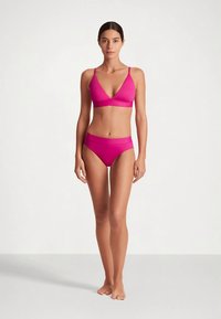 Fuksijas krāsas bikini komplekts ar trīsstūrveida braletu un atbilstošu hipsteru apakšdaļu. Gluda tekstūra un regulējamas lences ērtībai.