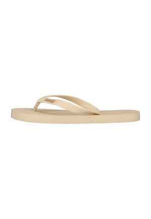 Beige rubberen teenslipper met een gestructureerde band en platte zool, zijaanzicht op een witte achtergrond.