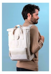 White roll-top backpack with a front zip pocket, padded straps, and logo detail. Made from durable material, featuring a sleek, minimalist design.
