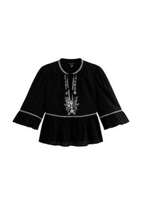 Blusa negra con un diseño floral bordado en blanco, escote redondo con lazo y mangas acampanadas con un dobladillo con volantes.