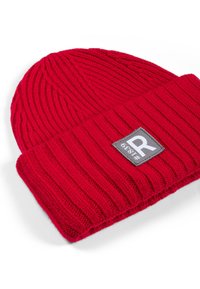 Red ribbed knit beanie with folded cuff and a sewn gray patch labeled "#1839 R" on the cuff.