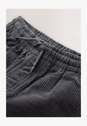 Dunkelgraue Cordhosen mit strukturierter Oberfläche, ausgestattet mit einem elastischen Bund und einem Kordelzug zur Anpassung.