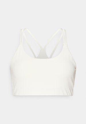 Soutien-gorge blanc en tissu lisse et extensible. Présente de fines bretelles croisées dans le dos, un décolleté arrondi et sans fermetures visibles.