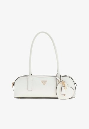 White Guess handbag with a long handle, black trim, triangular logo, and heart-shaped keychain with gold-tone accents.