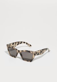 Square sunglasses with a translucent tortoiseshell pattern in beige and brown. Dark gray lenses and a logo accent on the temple.