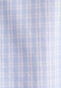 Tissu à carreaux bleu clair et blanc avec une texture fine tissée et des rayures verticales et horizontales formant un motif à carreaux.