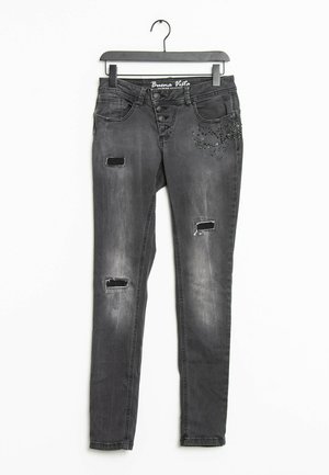 Jeans skinny de mezclilla negra con parches desgastados, acentos decorativos de rhinestones, cinco bolsillos y cierre frontal con botones.