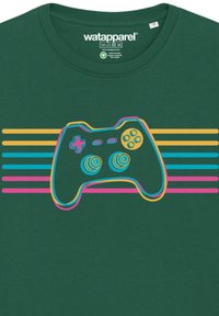 Green cotton t-shirt featuring a graphic of a game controller outlined in vibrant pink, yellow, and blue stripes against a solid background.